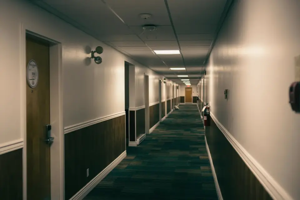 A hotel hallway with a Do Not Disturb sign hanging on a guest room door