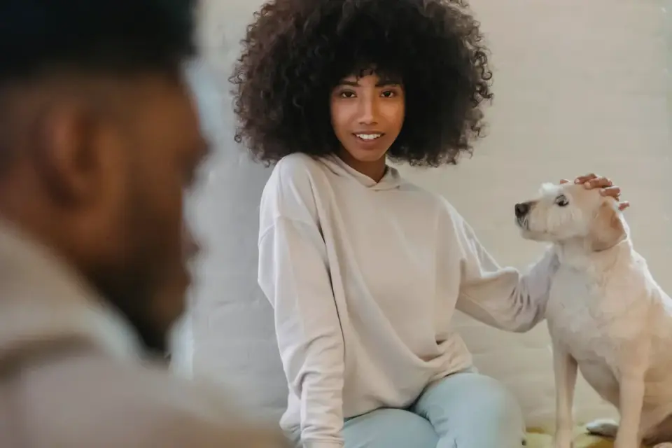 Dog in a kitchen with an owner