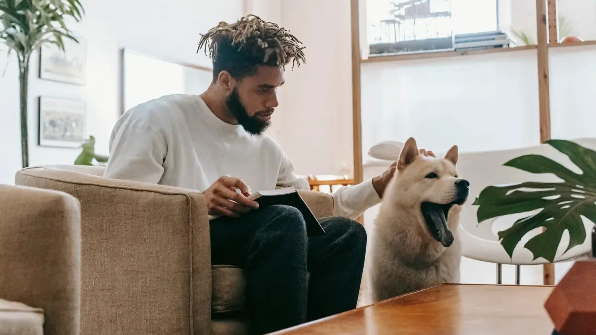 Dog owner checking label details beside a pet supplement container