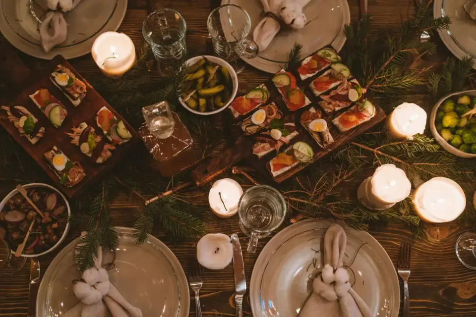 Dog sitting near a dinner table looking up at food during a holiday meal