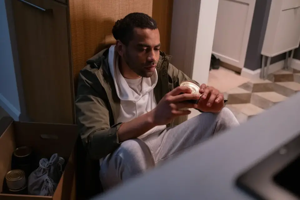 Owner checking the sodium content on a can of green beans in the kitchen
