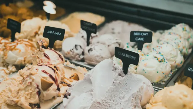 Several differently sized treat bags lined up on a kitchen counter next to a measuring scoop