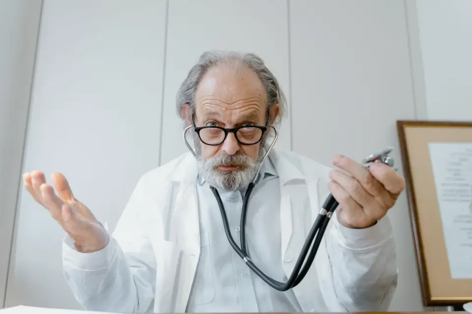 Veterinarian gently examining an older dog&#x27;s hips during a checkup